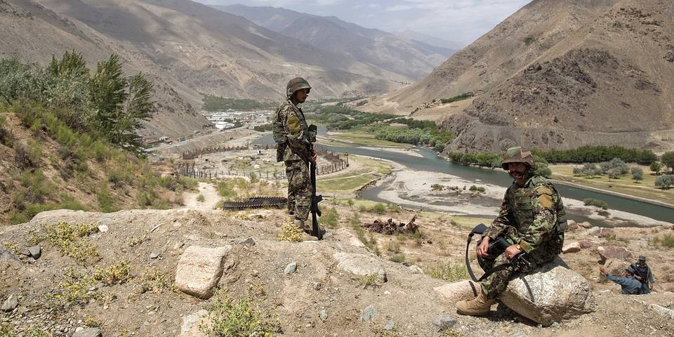 Afghan National Army soldiers keep watch along a road during a security handover ceremony in Panjshir province